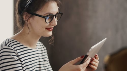 Smiling Young Women Using Digital Tablet In The Office
