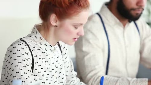 Young Adults Brainstorming Together at a Table