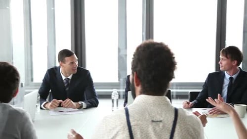 Office Workers Collaborate During a Presentation