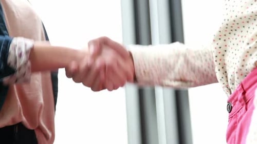 Close Up Of Male And Female Colleague Shaking Hands