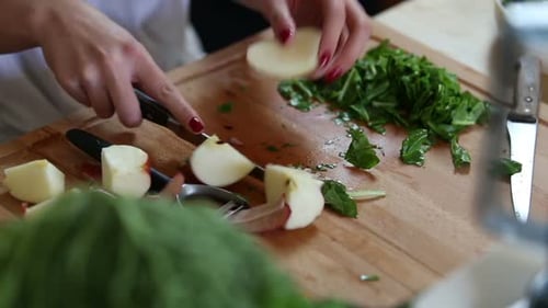 Close-Up Of Cutting Apple On Pieces
