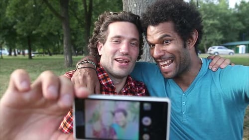Two Happy Young Adults Take Selfie in the Park