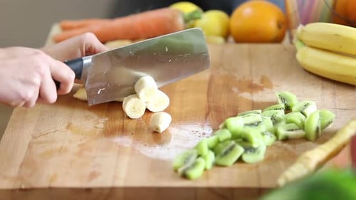 Close-Up Of Cutting Peeled Banana With Knife 2