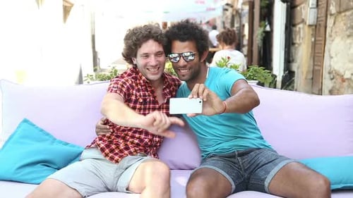 Young Men Taking a Selfie on Urban Sofa