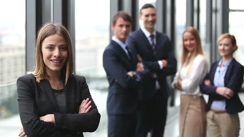 Confident Businesswoman with Team in Modern Office