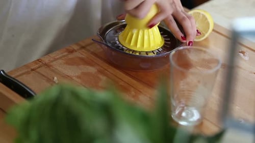 Close-Up Of Squeezing Lemon On Squeezer