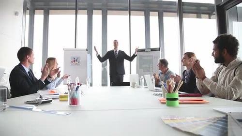 Colleagues Clapping for Speaker in a Meeting Room