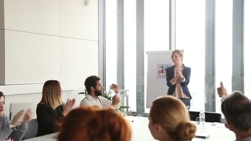 Colleagues Applaud Presenter in Modern Office
