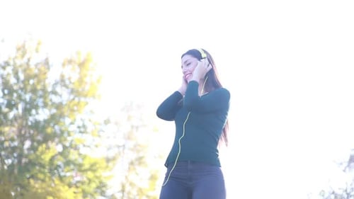 Smiling Woman Dances While Listening to Music
