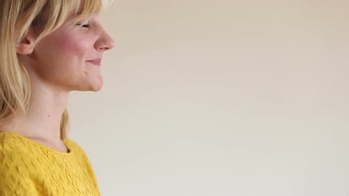 Young Woman Drinking Smoothie with Straw Indoors