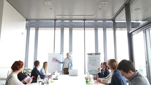 Corporate Team Attends Business Presentation in Modern Office