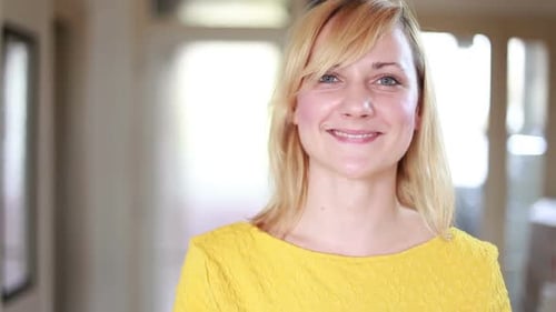 Woman Drinks Smoothie with Straw Smiling Indoors