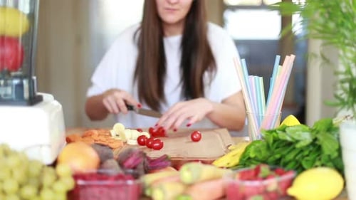 Woman Cutting Fresh Vegetables for Healthy Smoothie