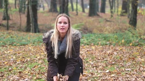 Happy Young Woman Smiling And Throwing Leaves In The Air 2