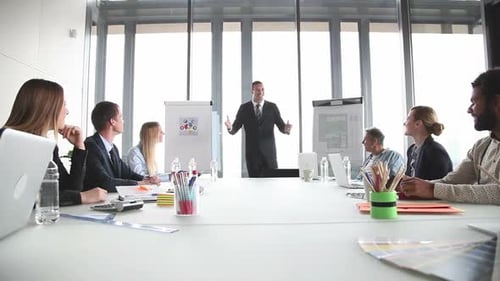Man Giving Presentation to Colleagues in Modern Office