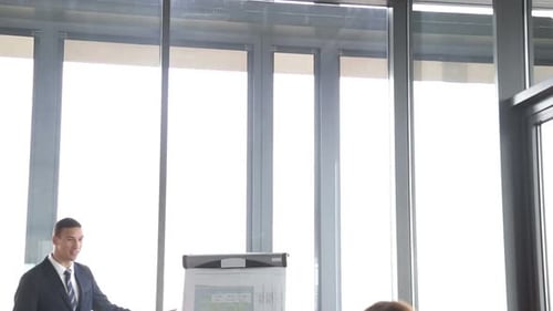 Young Adult Man Presenting at a Business Meeting