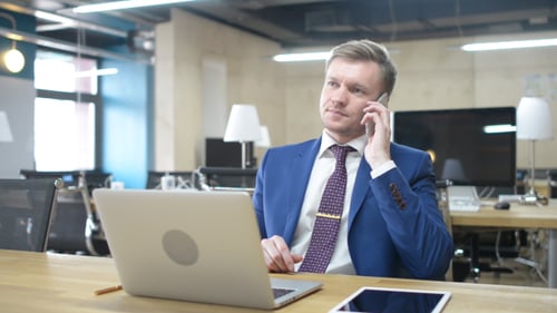 Professional Man Talking on Phone in Office Setting