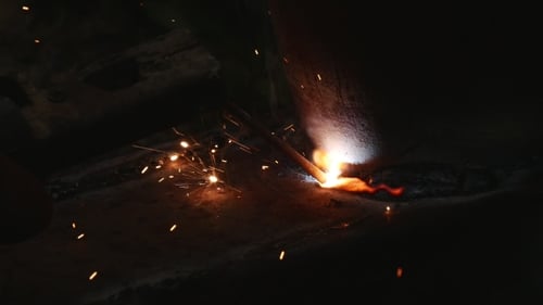 Welding Sparks and Smoke Close-Up in Dark Setting
