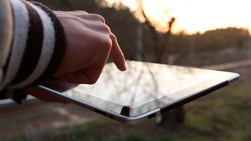Man Walks On The Street And Using Tablet