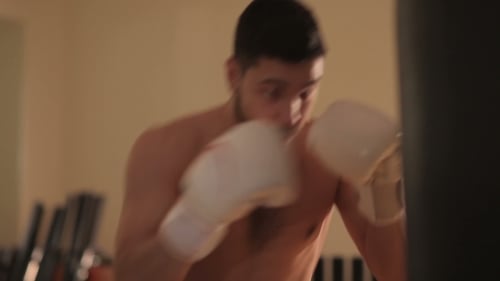 Man Punching a Bag During Boxing Workout