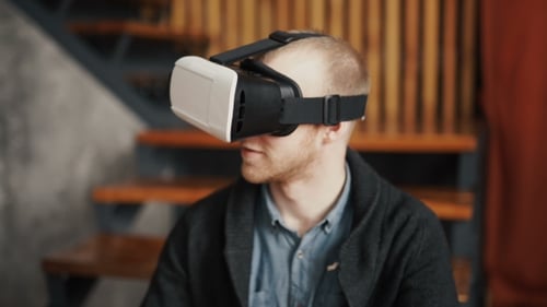 Man Wearing VR Headset Experiences Virtual Reality