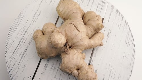 Fresh Ginger Root Close-up on White Wooden Surface
