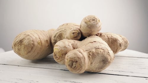 Fresh Ginger Root on White Wooden Surface