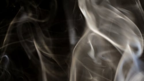 Wispy White Smoke Against Dark Background
