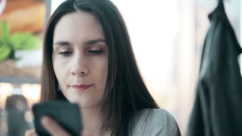 Beautiful Woman Using Smartphone In Cafe.