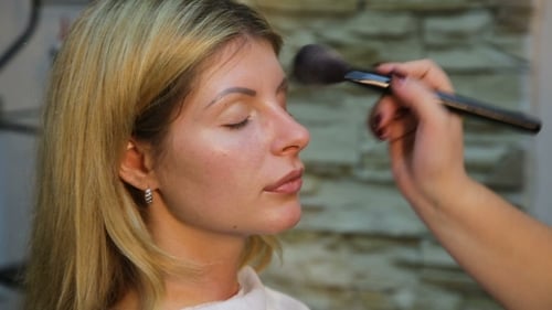 Woman Getting Makeup Applied with Brush Close Up
