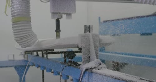 Surfboard being shaped by a machine in a workshop