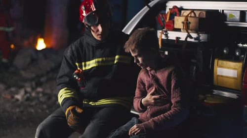 Rescuer Speaking with Teenager After Accident