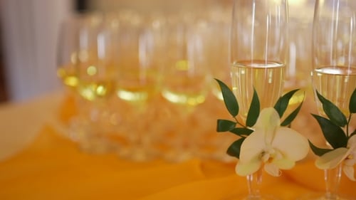 Decorated Champagne Flutes On Table During Wedding