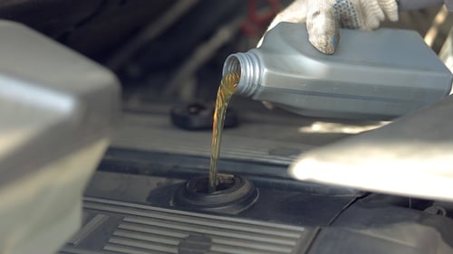 Pouring Oil into Car Engine