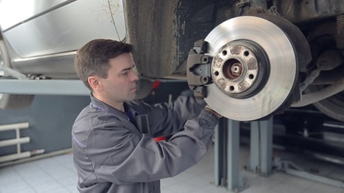 Man Changing Shoe of Brake