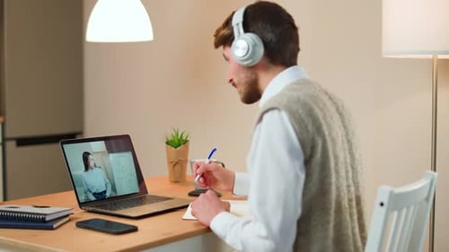 Man Attends Online Meeting from Home