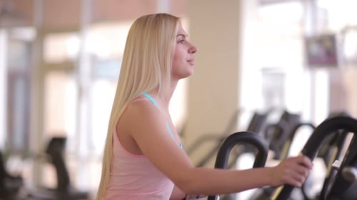 Beautiful Woman On Orbitrek Elliptical Trainer