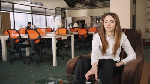 Young Woman At The Office Speaking On The Phone And Smile