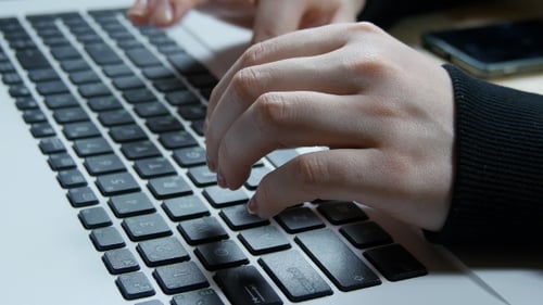 Close Up Hands Typing on Laptop Keyboard