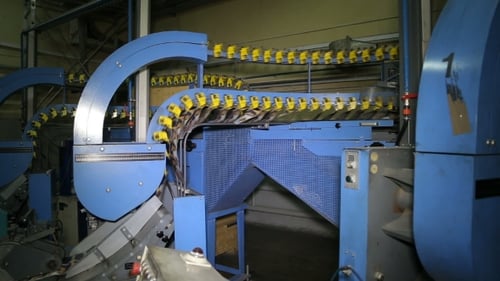 Les journaux circulent le long d'une chaîne de montage dans une usine.