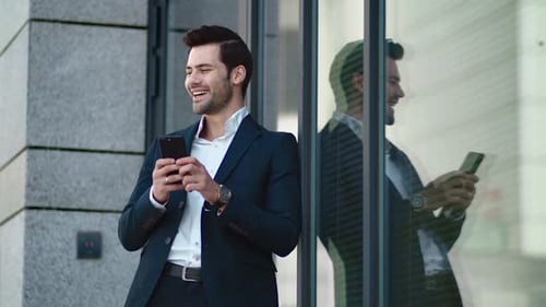 Closeup Man Standing in Black Suit at Street. Businessman Using Smartphone