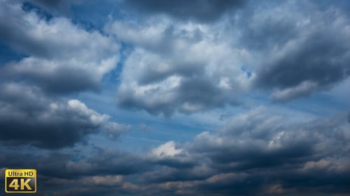 White Clouds Billow Across a Blue Sky