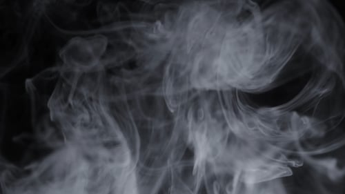 Wispy White Smoke Flowing on Black Background