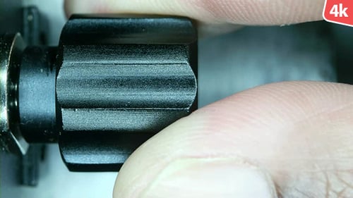 Turning a Black Adjustment Knob, Close Up