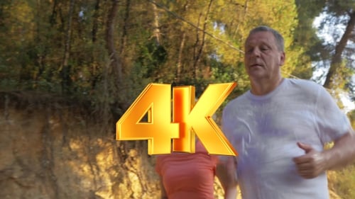 Mature Couple Jogging In Park