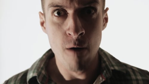 Angry man shouting closeup on white background