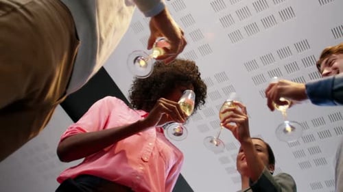 Happy Colleagues Celebrate with Champagne in Office