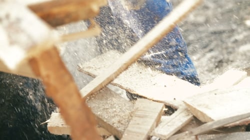 Wood Saw Cutting Lumber with Sawdust Flying