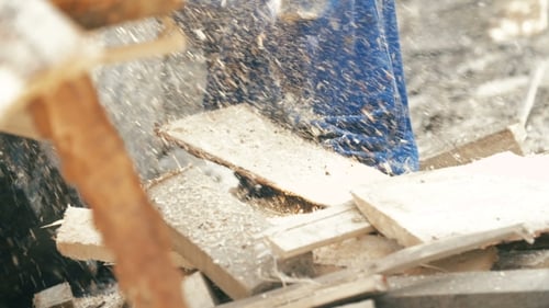 Saw Cuts Wood with Flying Sawdust