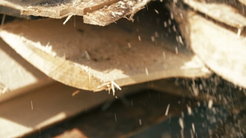 Wood Pieces and Sawdust Falling from Wooden Planks